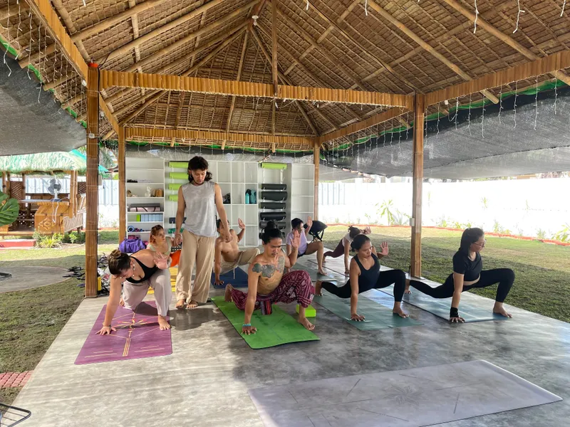 Yoga class in session at Tallaro pavilion during the grand opening, teacher guiding students on mats