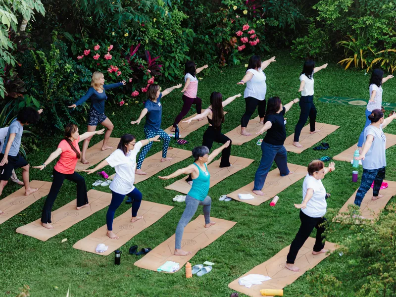 Guests in warrior pose on cork mats in the Tallaro garden