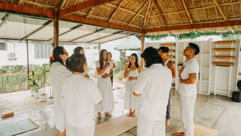 Retreat group dressed in white gathered under the pavilion