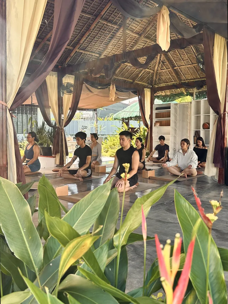Members seated in meditation in the Tallaro garden pavilion